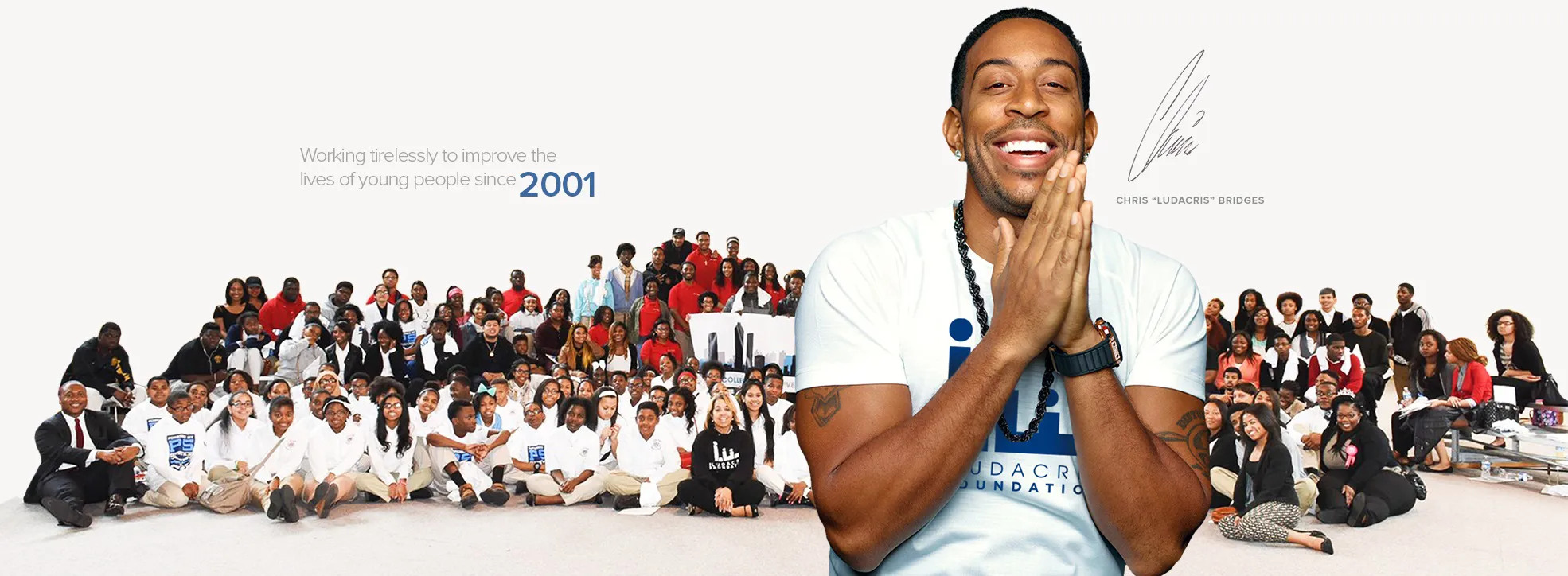 Ludacris in front of a group of the foundation's team members. Text reads 'Working tirelessly to improve the lives of young people since 2001.'